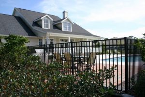 Home swimming pool in Frisco surrounded by a wrought iron fence